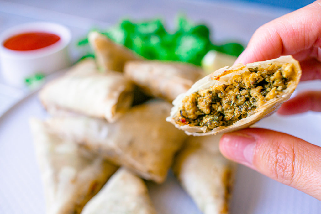 Chicken samosa being held